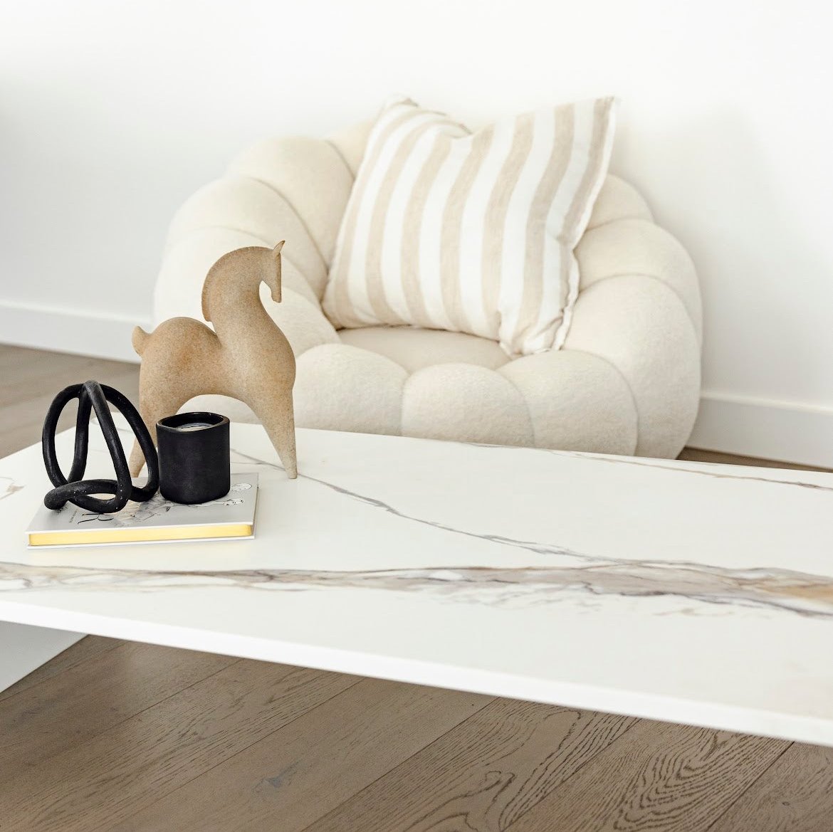Matteo Coffee Table with styled top and white boucle swivel chair 