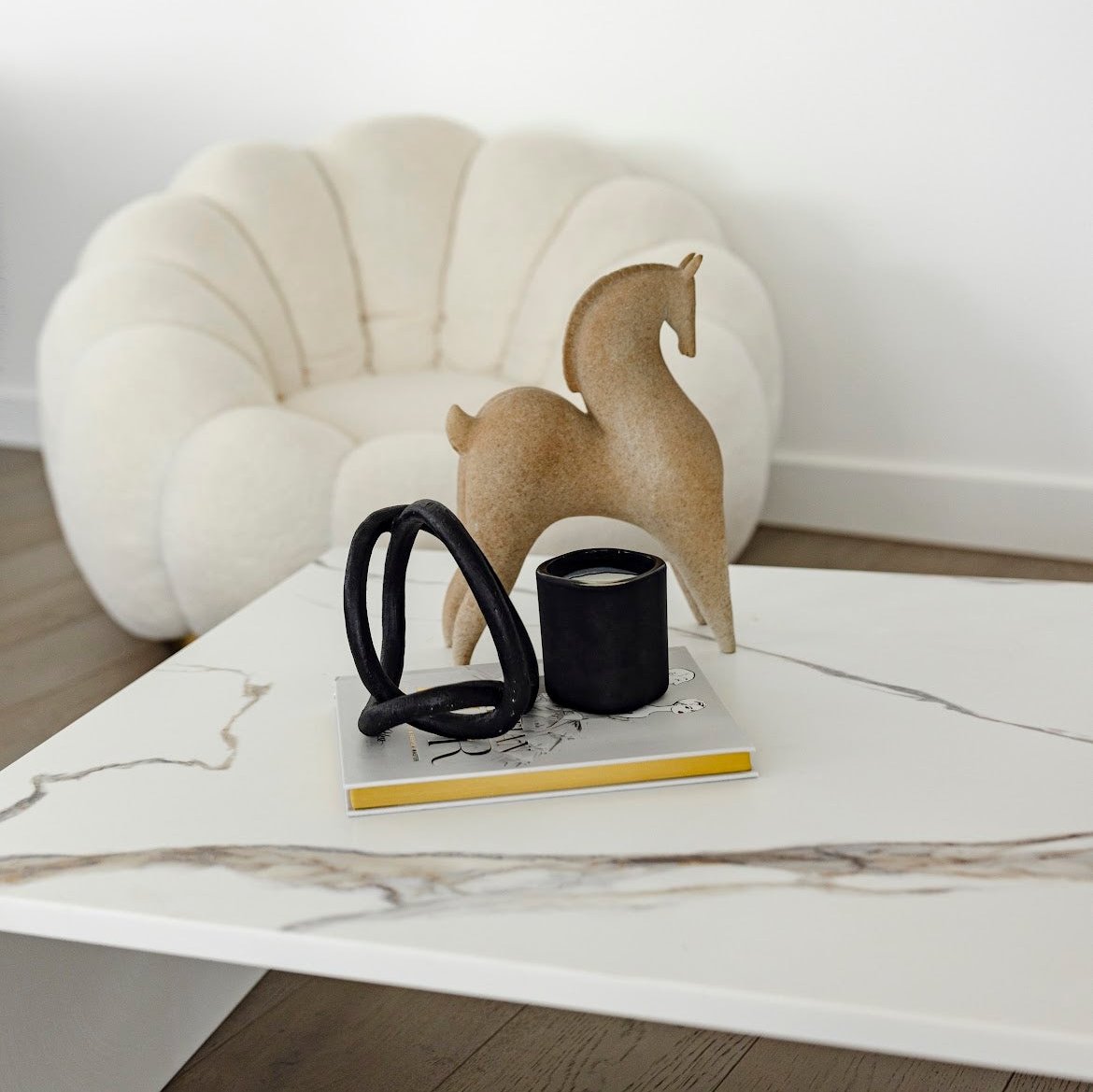 Matteo Coffee table by Annuello Styled with black candle, gold edge book and stone horse figurine