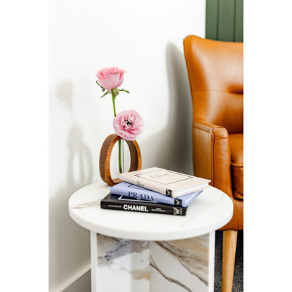 Arc Marble side table with vase with pink flowers and 3 accents books.